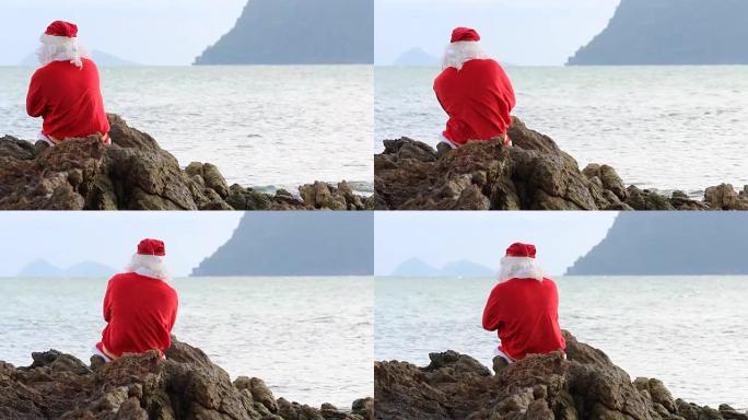 圣诞老人坐在岩石上跳舞