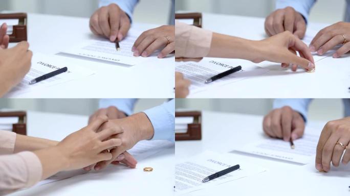 夫妇签署离婚政策，女人从手指上摘下订婚戒指