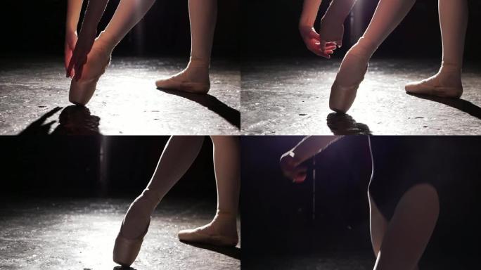 穿着脚尖鞋的年轻芭蕾舞演员美丽的腿。芭蕾舞练习。芭蕾舞者美丽纤细优美的双腿。