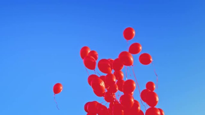 带有 “出售” 字样的SLO MO LD红色气球漂浮在蓝天上