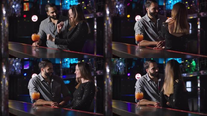 自信的年轻中东男人来到迷人的高加索女孩在酒吧柜台旁跳舞。帅哥在夜总会和美女调情。电影院4k ProR