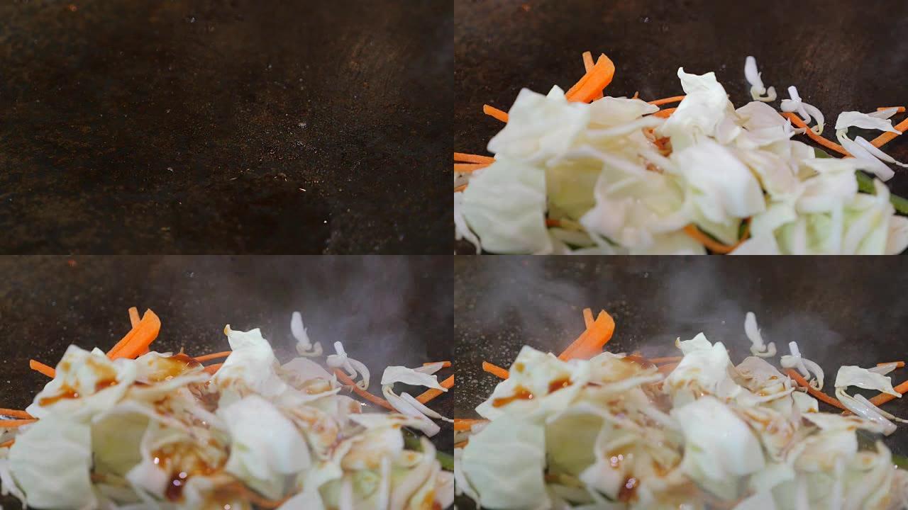 铁板烧锅炒蔬菜。前视图。