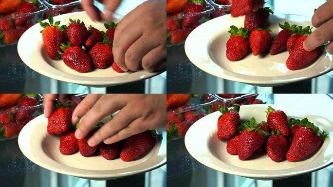 草莓布置得很漂亮。在白色盘子上。
