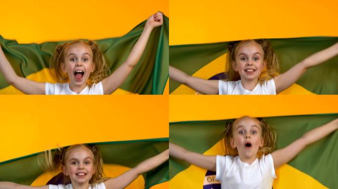 挥舞巴西国旗的小球迷孩子，为国家运动队加油，支持