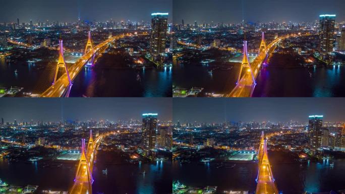 泰国曼谷夜间，普密蓬悬索桥在曼谷市湄南河上空的空中俯视，汽车在桥上。