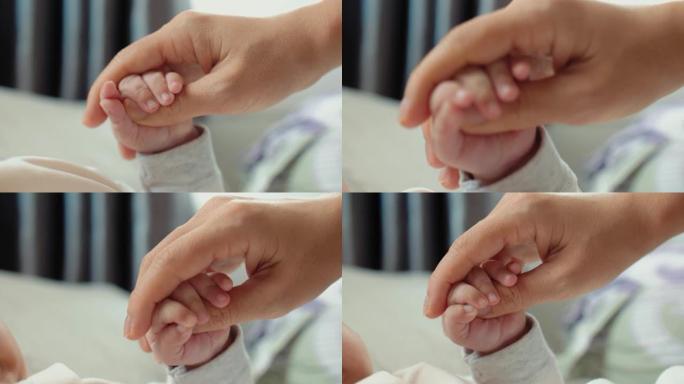 CU: 母亲握着婴儿的手