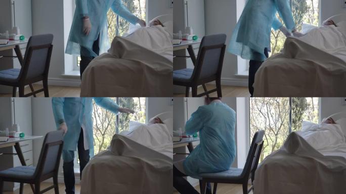 男性白人医生来咳嗽的女病人躺在床上，检查设备是否有机械通气。医务人员照顾患有新型冠状病毒肺炎的妇女。