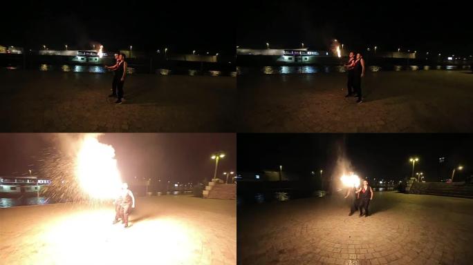 这两个人呼吸着火杂技表演火焰表演嘴巴喷火