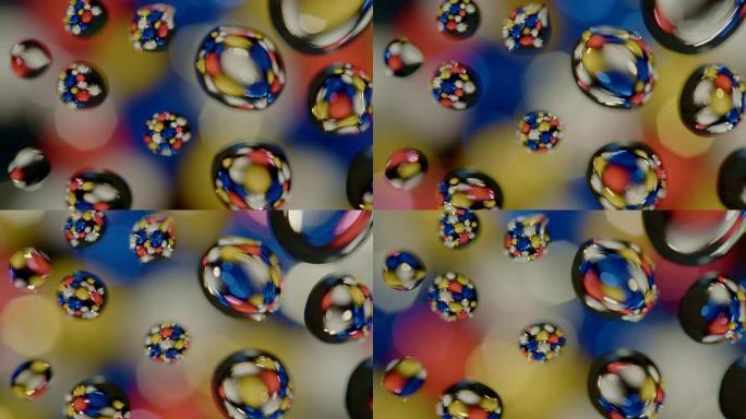抽象背景彩色闪光球在玻璃上旋转水滴