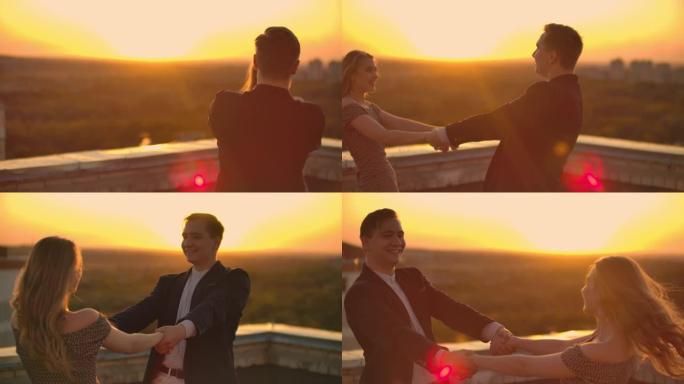 一个恋爱中的男人和一个女人在日落时站在建筑物的屋顶上跳舞，互相看着对方