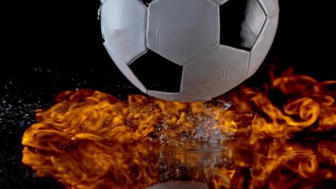 SLO MO LD足球从表面反弹时点燃火焰