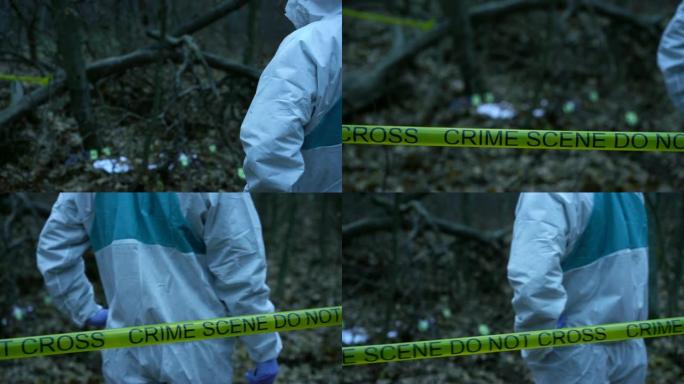 身着防护服的法医专家在森林犯罪现场，谋杀现场工作