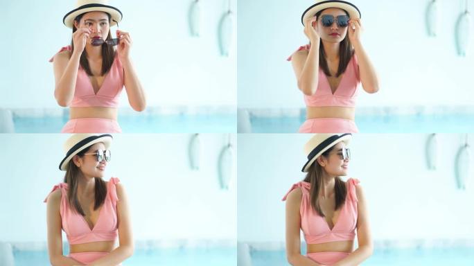 4k镜头比基尼美女坐在游泳池边戴着墨镜