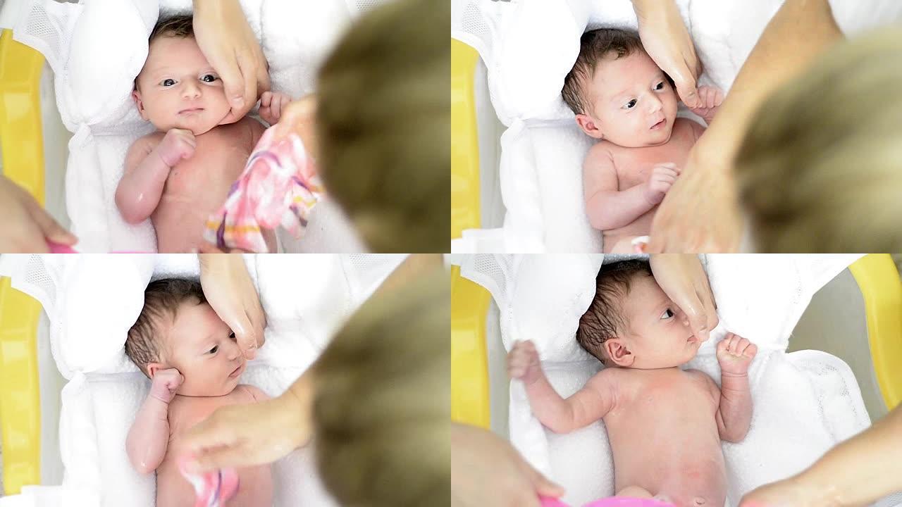 两天大的新生婴儿洗澡的镜头。