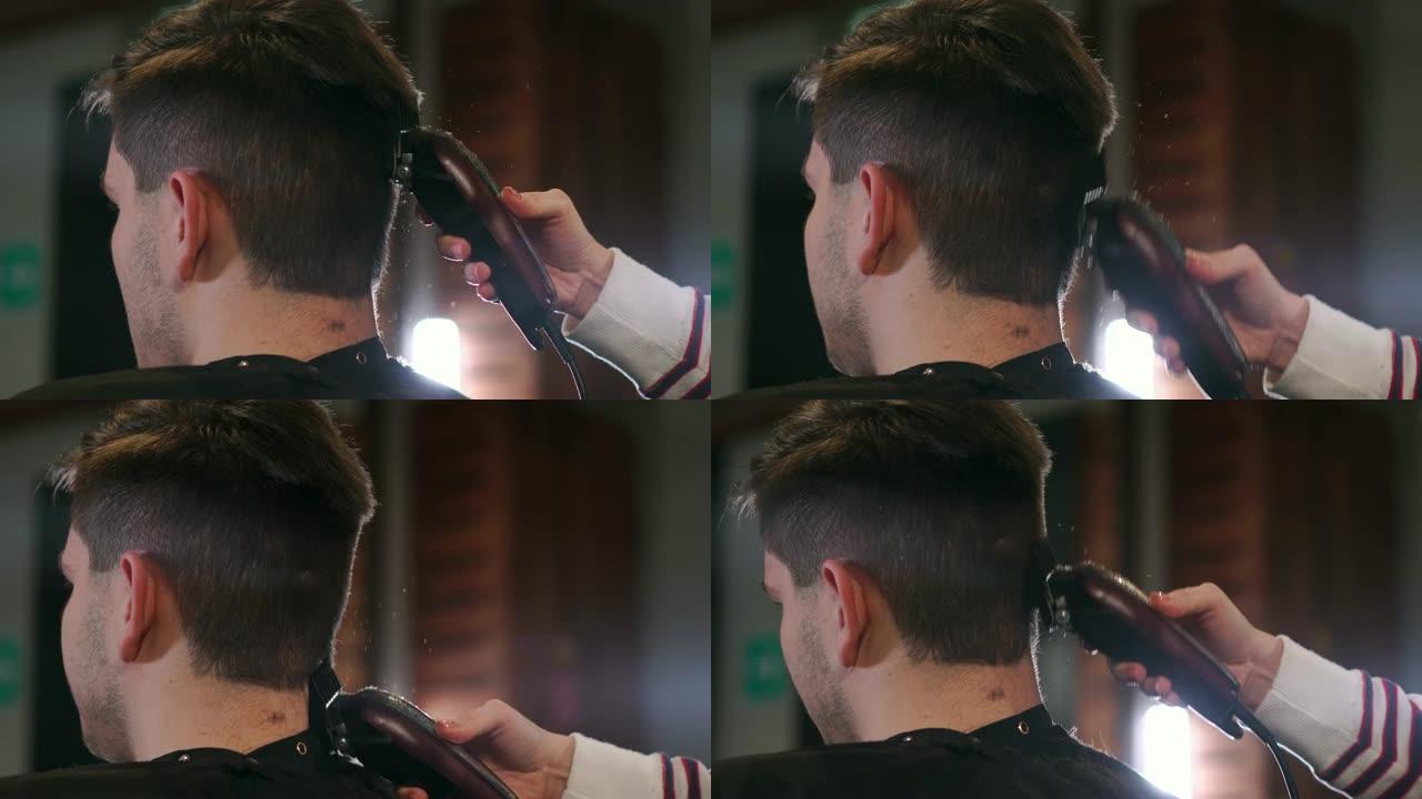 理发师工具。男性手刷电动理发推子的特写。理发师为下一个客户准备发胶机。男士清洁黑色剃须机