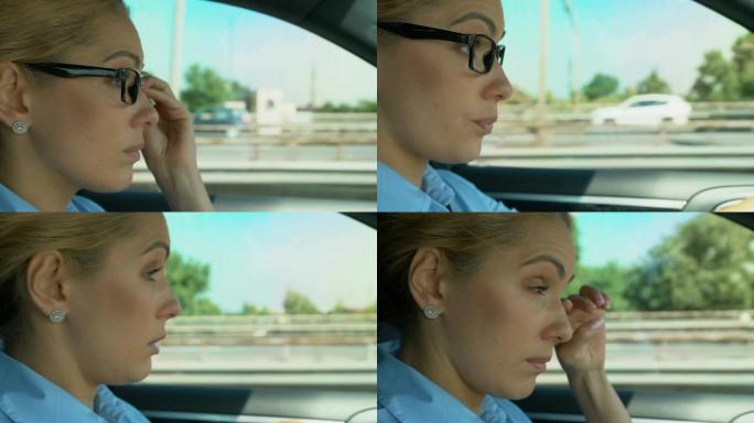女人在开车时戴上和摘下眼镜，视力模糊，视疲劳
