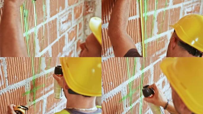 建筑工人用喷漆在墙上画测量值