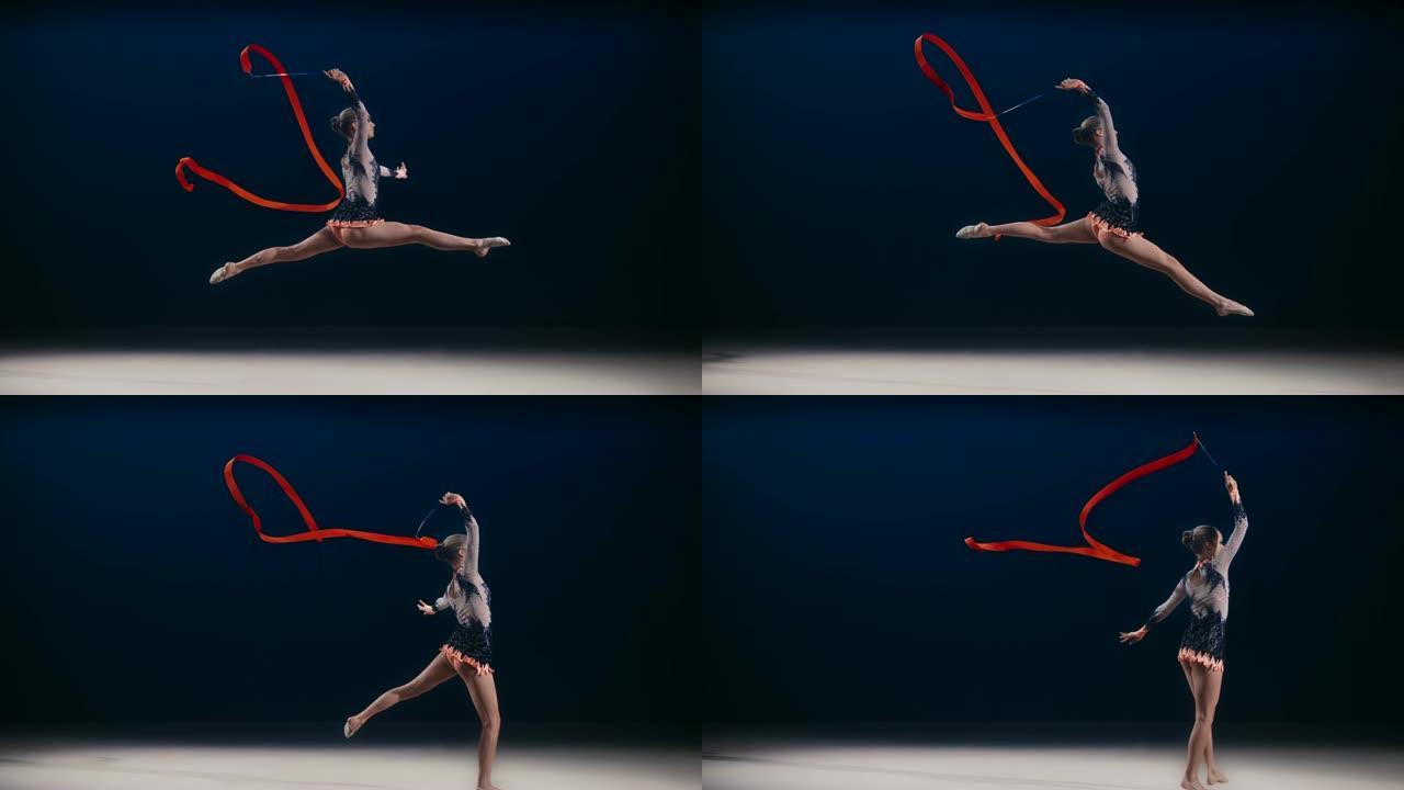 SLO MO SPEED RAMP LD艺术体操运动员在一次跳跃中在头顶上方旋转一条红丝带