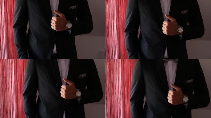 带领带和漂亮手表的黑色套装