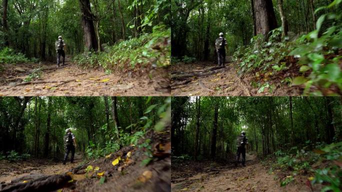 男子在森林小径上徒步旅行
