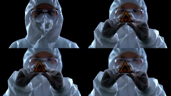 穿着制服的科学家向相机显示易燃物，破坏性物质