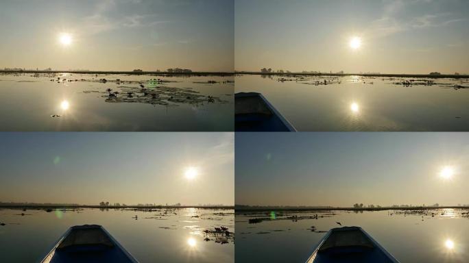 早上日出在泰国乌隆他尼的粉红莲湖乘船旅行。