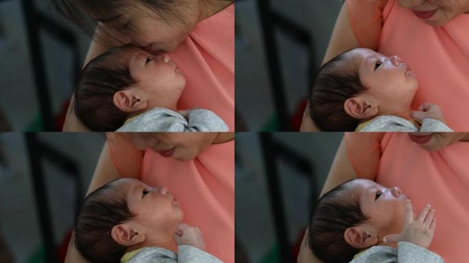 妈妈亲吻宝宝的爱妈妈亲吻小婴儿刚出生的婴