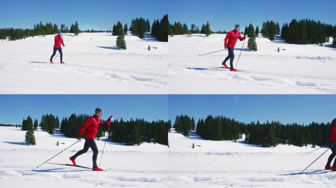 在科罗拉多州一个阳光明媚的冬日，一名五十多岁的男子在山上进行越野滑雪的慢动作镜头