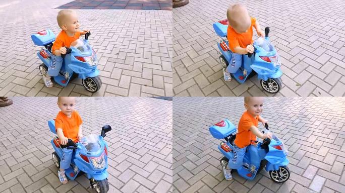 小男孩在公园骑玩具摩托车