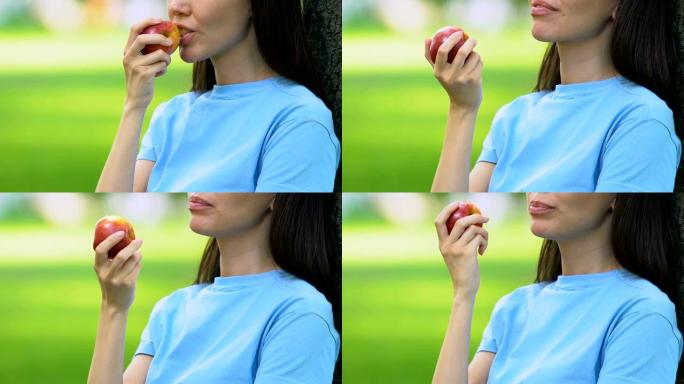 美女户外吃甜苹果，健康零食，维生素，营养