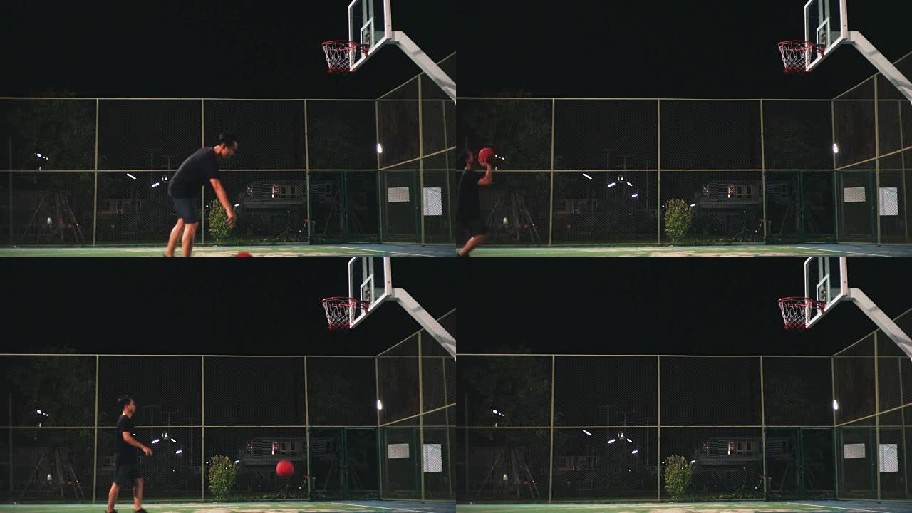 一个人晚上独自在室外球场打篮球。