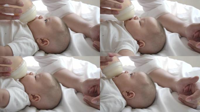 慢动作妈妈正在用奶瓶哺乳。