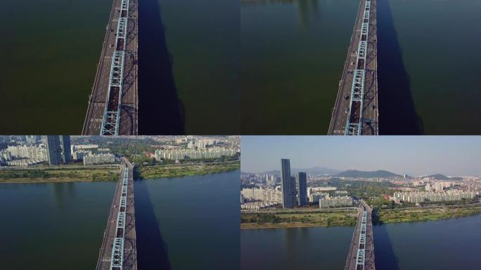 韩国首尔市，在汉江上空穿越汉江进入乐天世界塔的桥梁上行驶的汽车的鸟瞰图