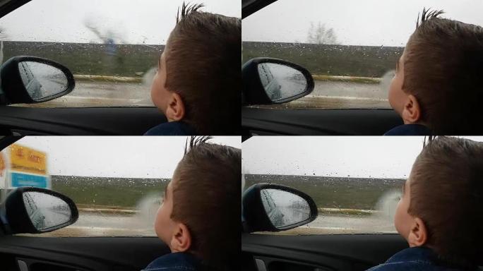 雨天开车的小男孩