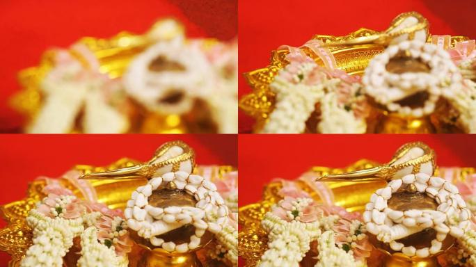 泰国传统婚礼设置泰国风格的花环花装饰和海螺。