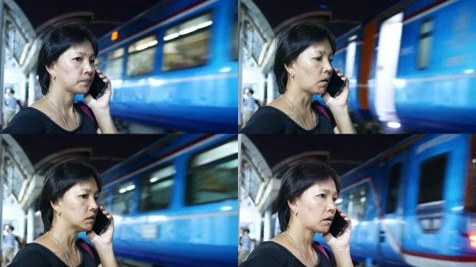 等待火车时使用电话的成熟女人
