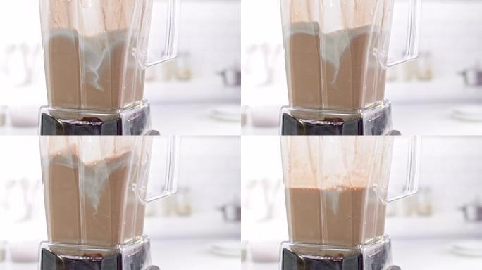 混合牛奶和巧克力糖浆的SLO MO LD搅拌机