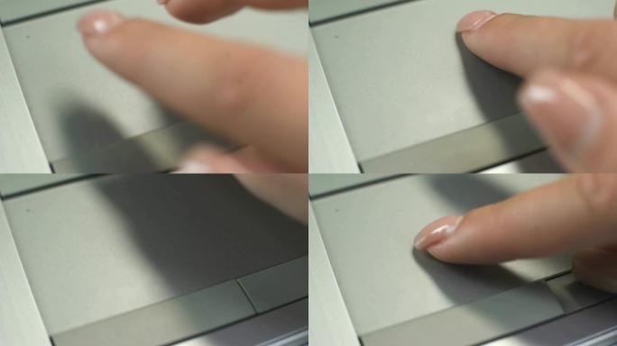 女人在笔记本电脑上使用触摸板移动指针并缩放文本，图像或网页