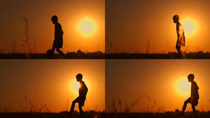 在海滩上踢足球或踢足球的男孩的剪影，带有美丽的日落背景，童年，宁静，运动，生活方式的概念