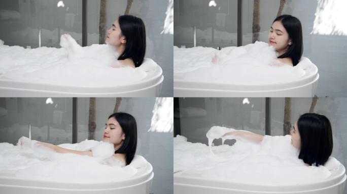 4k亚洲女孩她正在热水浴缸里洗澡。