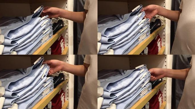 亚洲男孩在零售店选择衣服