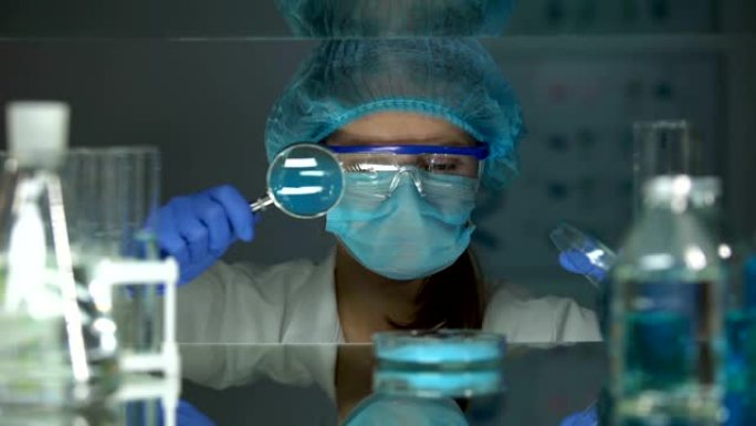 研究人员用放大镜分析蓝色颜料，染料粉剂