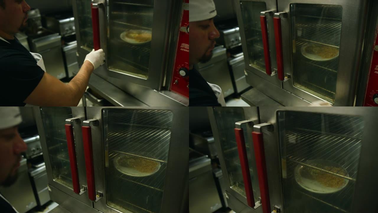 三十多岁的西班牙裔男厨师在墨西哥一家餐厅的商业烤箱中放置一盘食物
