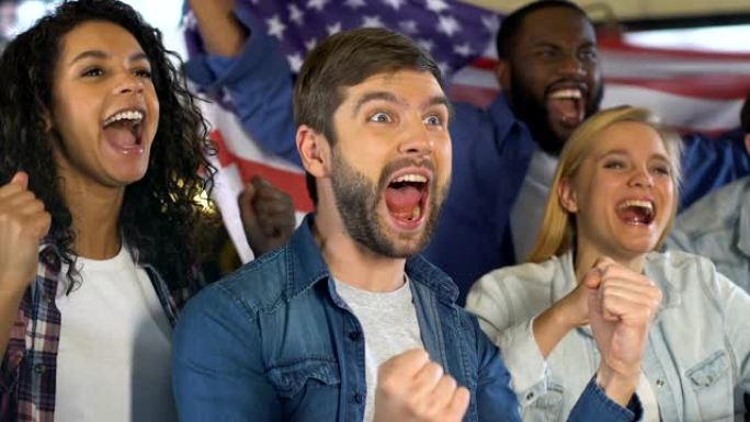 球迷在酒吧里举着美国国旗庆祝国家足球队的胜利