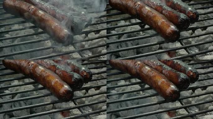 热狗在烤架上用热烟煤做饭