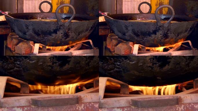 在印度德里的大街上，传统的金属煎锅在煤气炉上加热