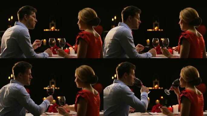 男女在餐厅品尝红酒，相亲夫妇共进晚餐