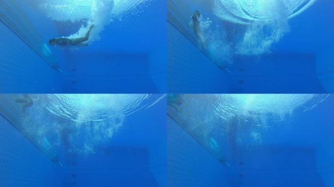 一名女子跳水运动员降落在游泳池的水下视图
