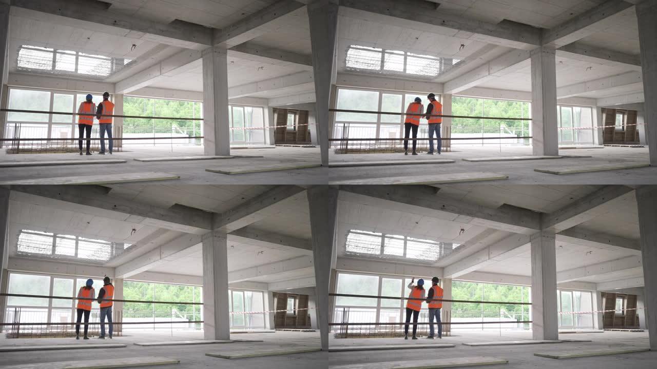 LD女服务员和男建筑师站在大楼里，一边聊天，一边检查施工细节