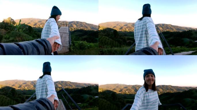 女人带领男友走向美丽的大自然在泰国